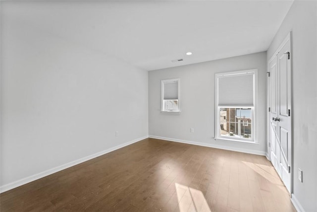 spare room featuring wood-type flooring