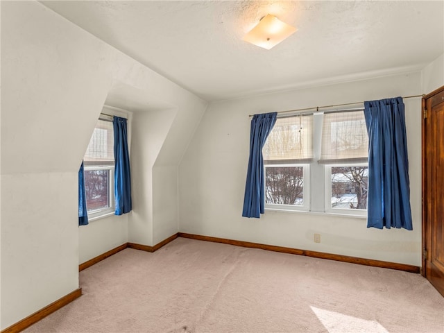 bonus room with carpet floors and vaulted ceiling