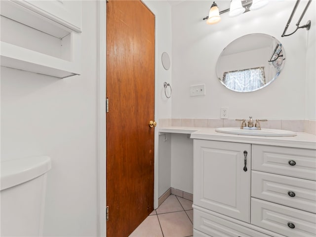 bathroom featuring vanity, toilet, and tile patterned flooring