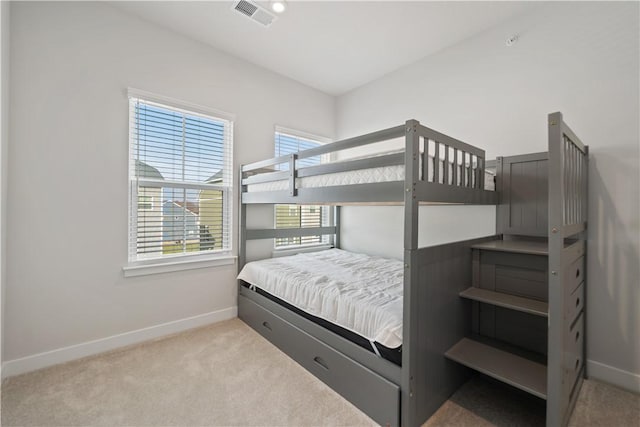 bedroom featuring light colored carpet