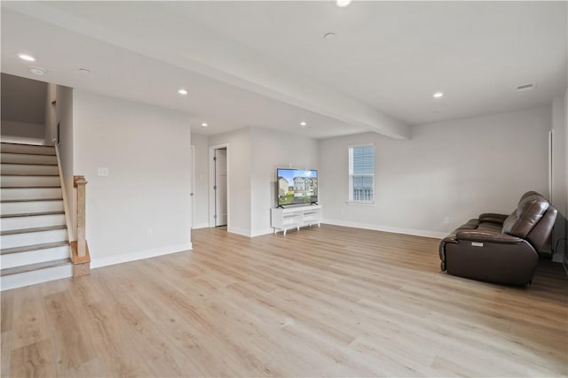 unfurnished living room with light hardwood / wood-style flooring and beam ceiling