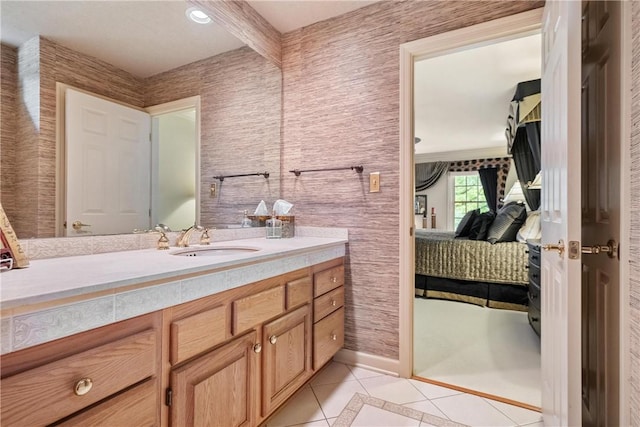 bathroom with beamed ceiling, tile patterned flooring, and vanity