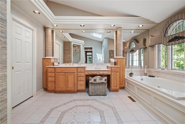 bathroom with ornate columns, tile patterned flooring, a washtub, vanity, and lofted ceiling