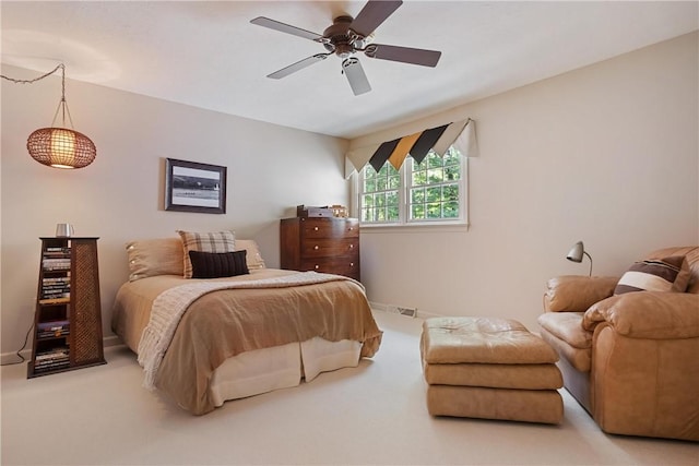 bedroom with ceiling fan and light carpet