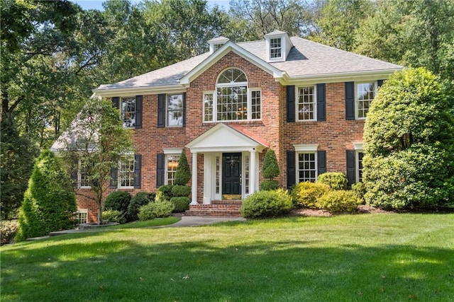 colonial home with a front yard