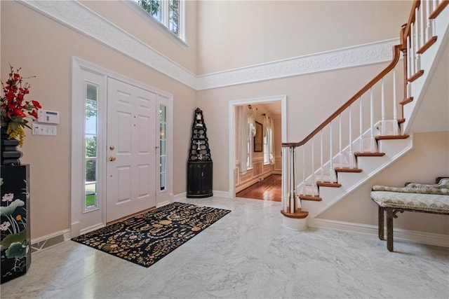 entrance foyer featuring a towering ceiling