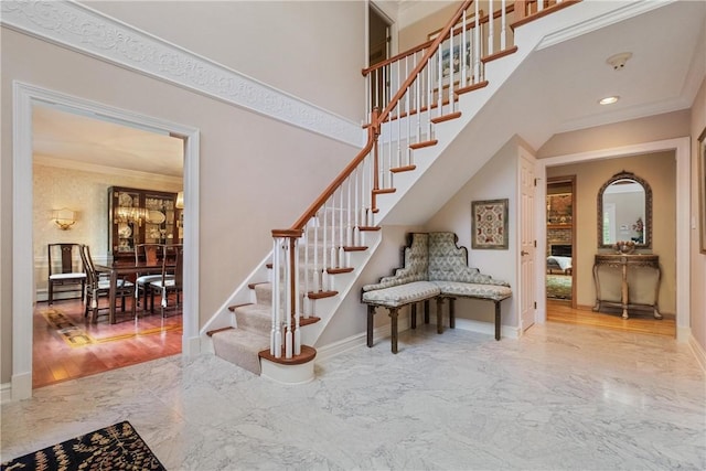 staircase featuring ornamental molding