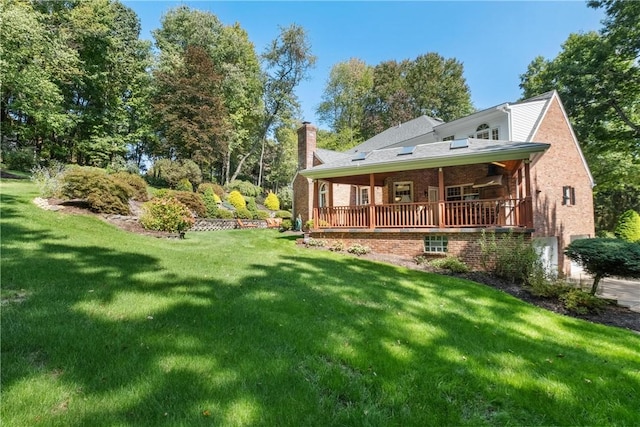 rear view of house featuring a lawn