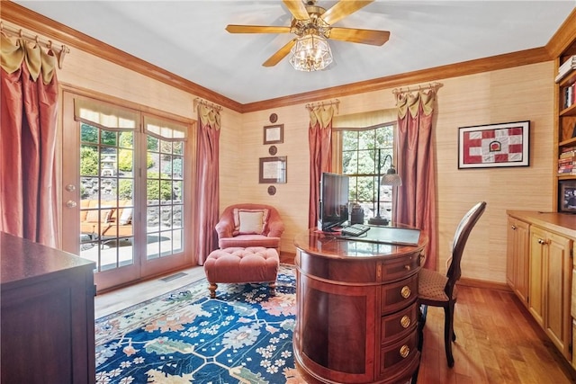 office featuring light wood-type flooring, ceiling fan, and crown molding