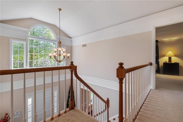 stairs with carpet, crown molding, lofted ceiling, and a notable chandelier