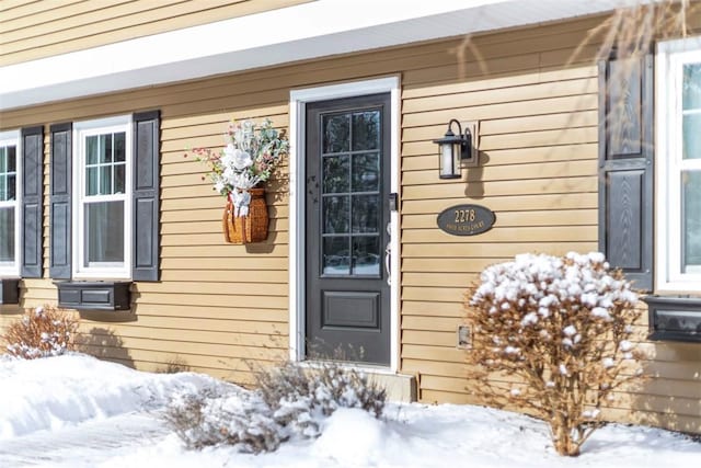 view of snow covered property entrance