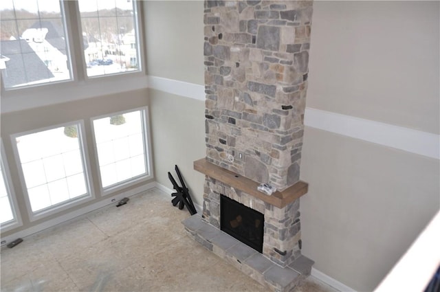 living room featuring a stone fireplace