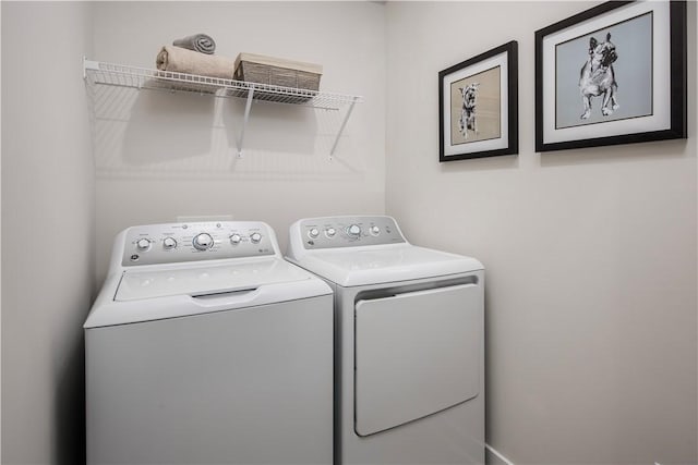 clothes washing area featuring separate washer and dryer