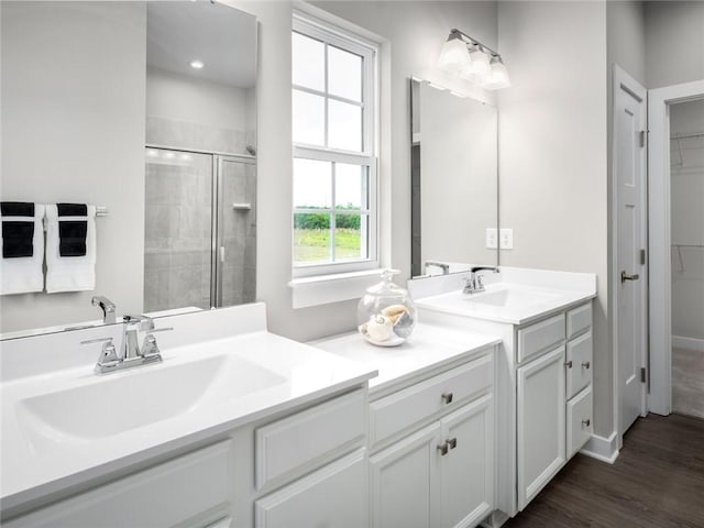 bathroom featuring vanity, hardwood / wood-style floors, and a shower with door