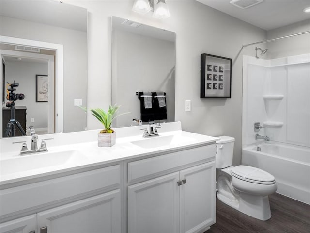 full bathroom with vanity, hardwood / wood-style flooring, shower / tub combination, and toilet