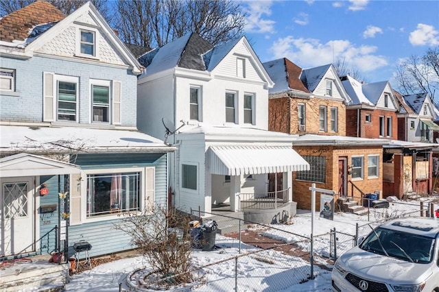 view of snow covered back of property