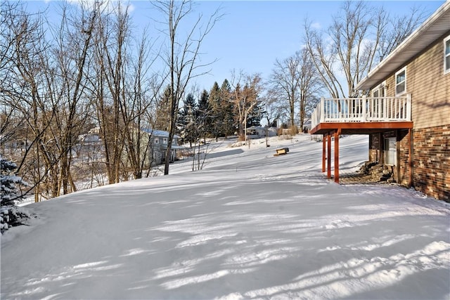 snowy yard with a deck