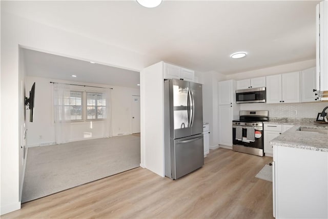 kitchen with light hardwood / wood-style floors, sink, white cabinetry, and stainless steel appliances