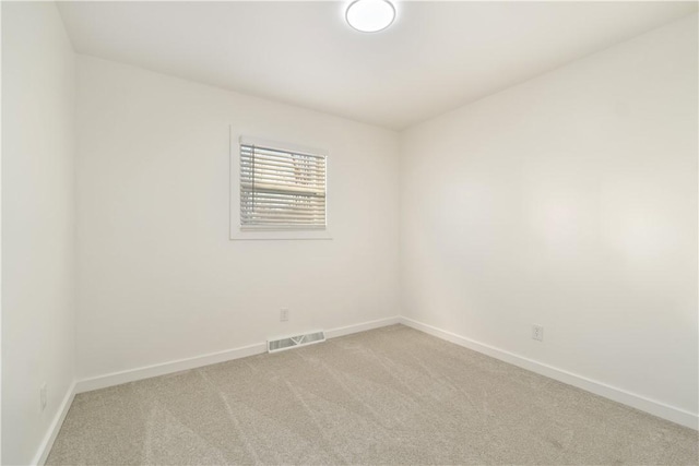 spare room with light carpet