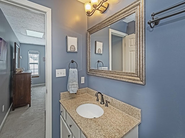 bathroom featuring vanity and a textured ceiling