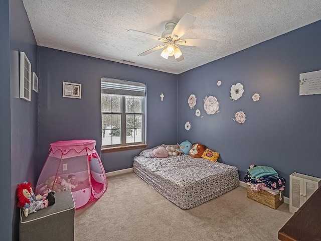 carpeted bedroom with ceiling fan and a textured ceiling