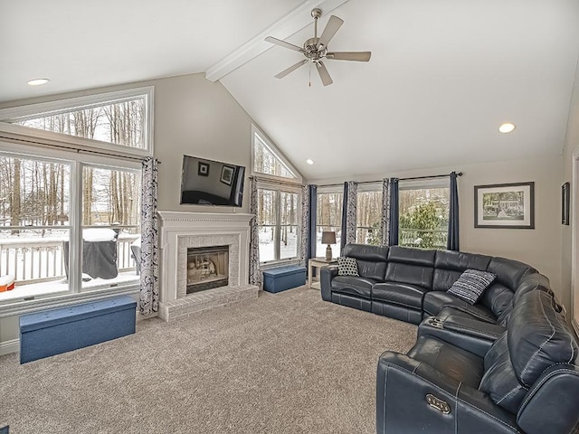 living room featuring ceiling fan, carpet floors, a brick fireplace, and vaulted ceiling with beams