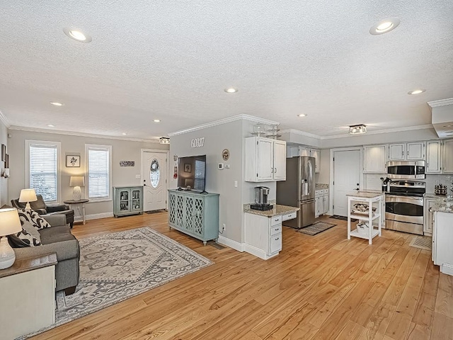 living room featuring crown molding, a textured ceiling, and light hardwood / wood-style floors