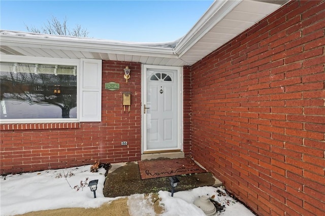 view of snow covered property entrance