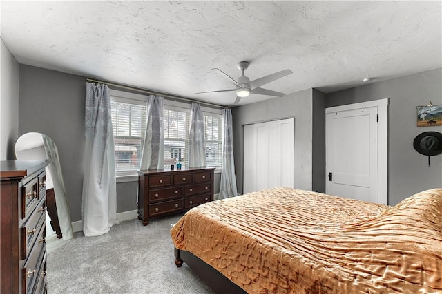 bedroom with a textured ceiling, a closet, and ceiling fan