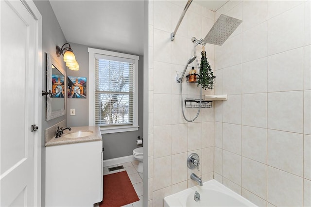 full bathroom with toilet, tiled shower / bath, tile patterned flooring, and vanity