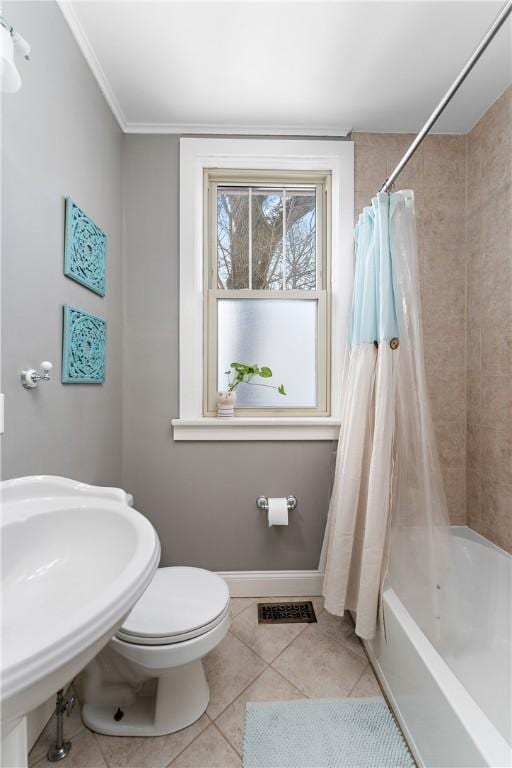 bathroom featuring tile patterned floors, toilet, crown molding, and shower / bath combination with curtain