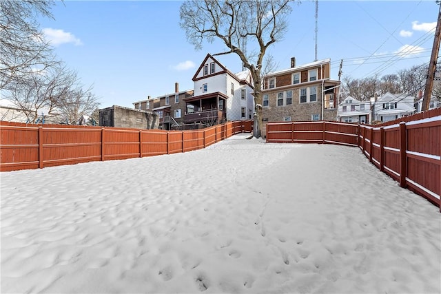 view of yard layered in snow