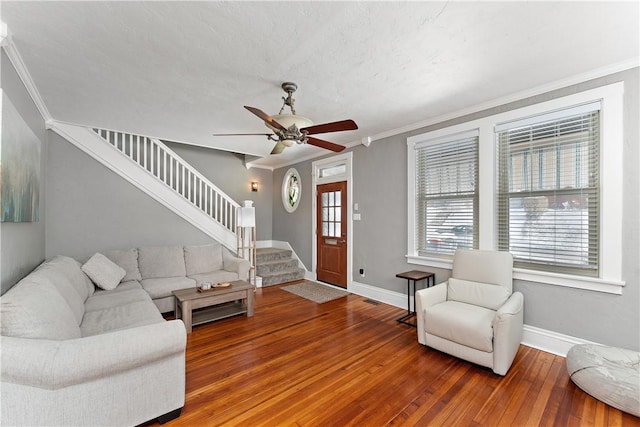 living room featuring ceiling fan, hardwood / wood-style floors, and crown molding