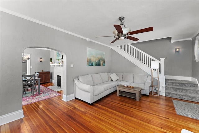 living room with crown molding, hardwood / wood-style flooring, and ceiling fan