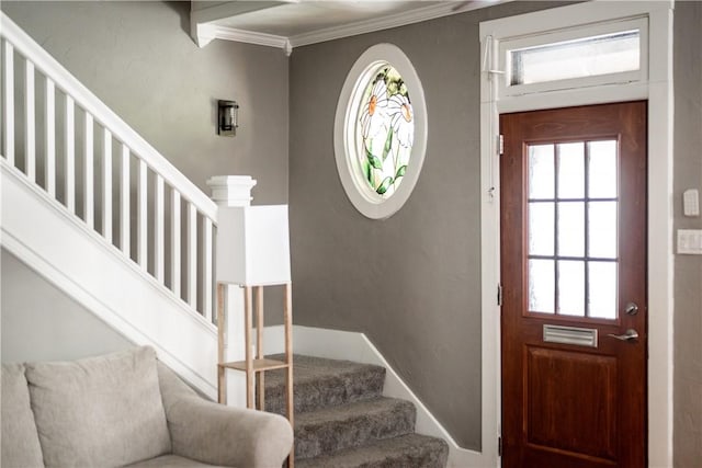 entryway featuring crown molding