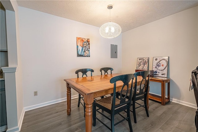 dining area with electric panel, a textured ceiling, and dark hardwood / wood-style flooring