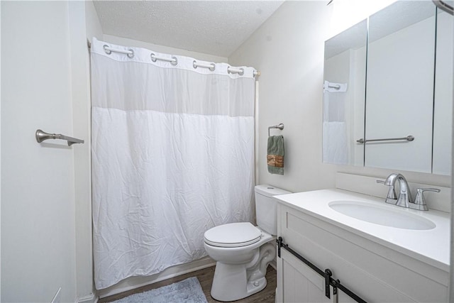 bathroom featuring curtained shower, hardwood / wood-style floors, toilet, a textured ceiling, and vanity