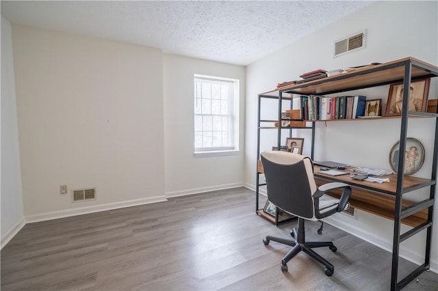 office featuring a textured ceiling and wood-type flooring