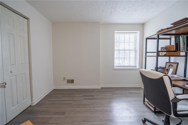 office space with a textured ceiling and dark hardwood / wood-style floors