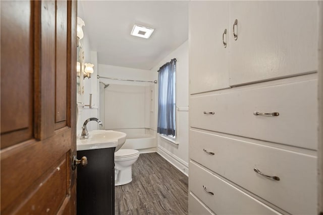 full bathroom with hardwood / wood-style floors, toilet, vanity, and  shower combination