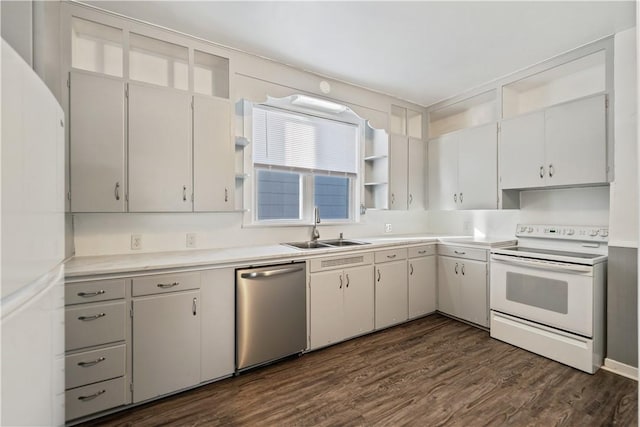 kitchen with sink, white appliances, dark wood-type flooring, and white cabinets