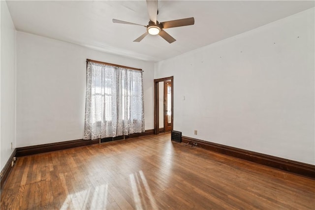 empty room featuring wood-type flooring and ceiling fan