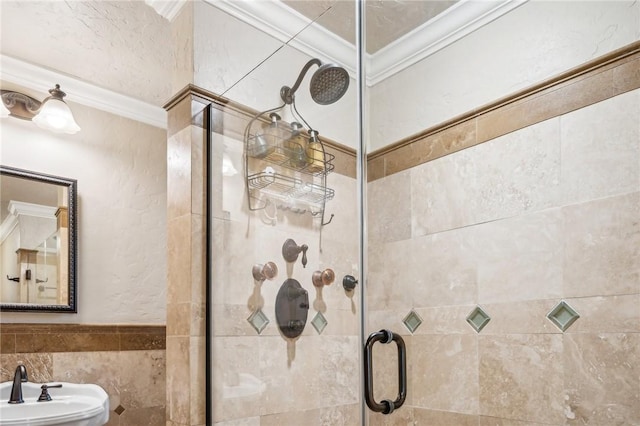 bathroom featuring sink, tile walls, an enclosed shower, and crown molding