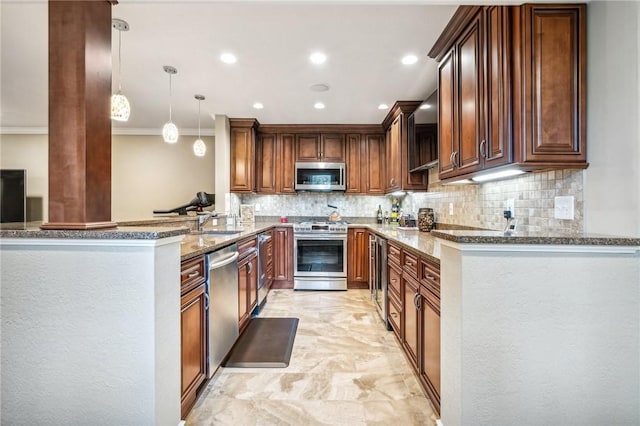 kitchen featuring kitchen peninsula, light stone counters, hanging light fixtures, and stainless steel appliances