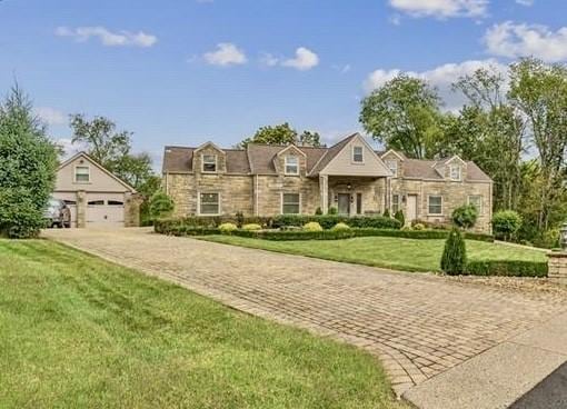 view of front of property with a front yard and a garage