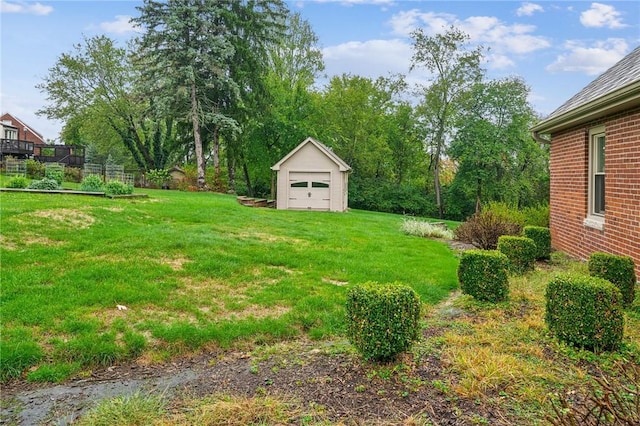 view of yard with a garage and an outdoor structure