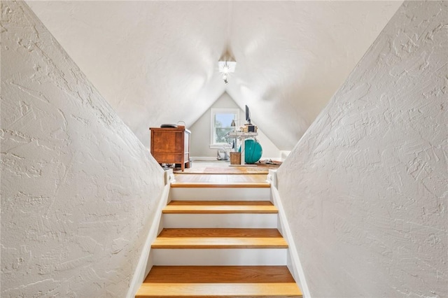 staircase with vaulted ceiling