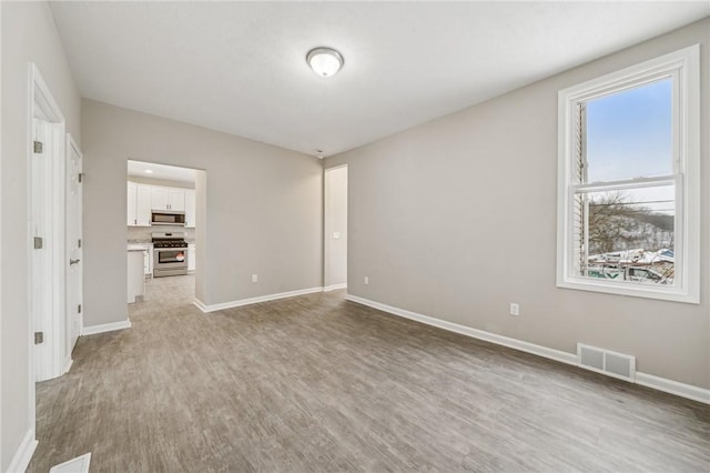 spare room featuring light wood-type flooring