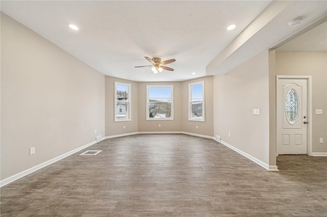 interior space with ceiling fan and dark hardwood / wood-style flooring