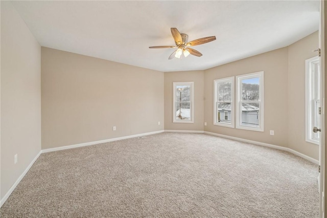 carpeted spare room with ceiling fan